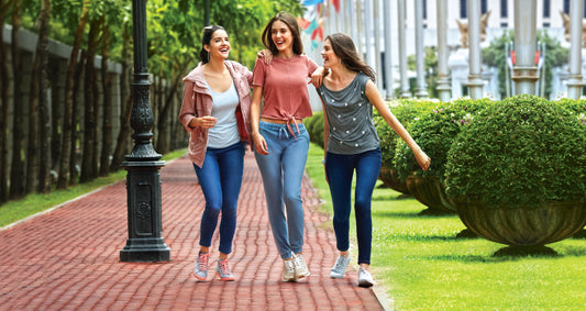 Image of three women laughing among each other and walking, dressed in Go Colors Cenim wear.
