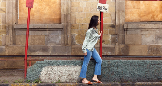 Side profile image of a woman staring at something while dressed in Go Colors Jeans.