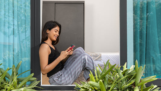 Image of woman sitting on her window, wearing Go Colors Loungewear.