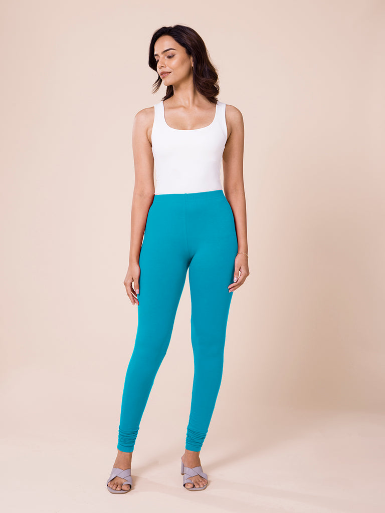 Premium AI Image | In the gym a woman in turquoise women workout leggings  lifts weights
